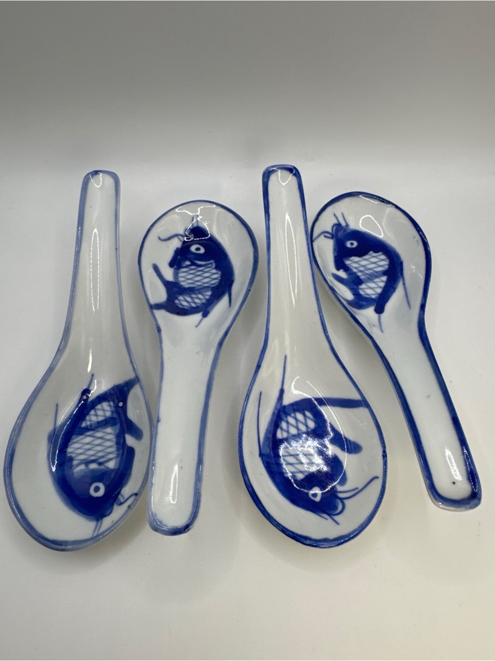 Lot of 4 Blue and White Ceramic Asian Soup Spoons Fish Motif Made in China